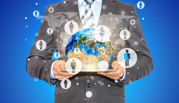 Businessman hold tablet pc, Earth and contacts Stock photo © cherezoff