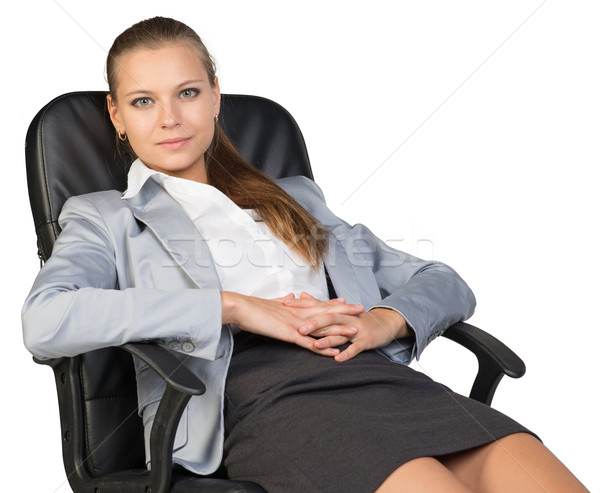 Businesswoman back in office chair, with hands clasped over her stomach Stock photo © cherezoff
