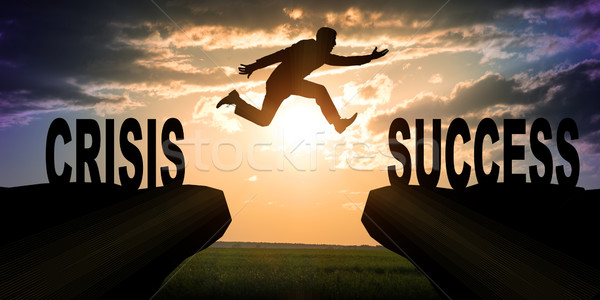 Businessman with hopping over abyss  Stock photo © cherezoff