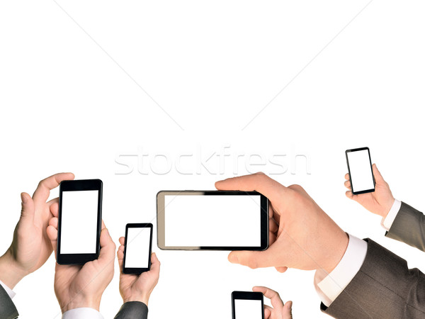 Mans hands using smart phones Stock photo © cherezoff