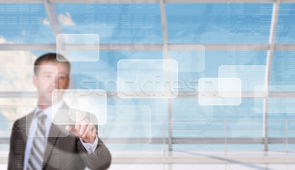 Businessman pressing on holographic screen Stock photo © cherezoff