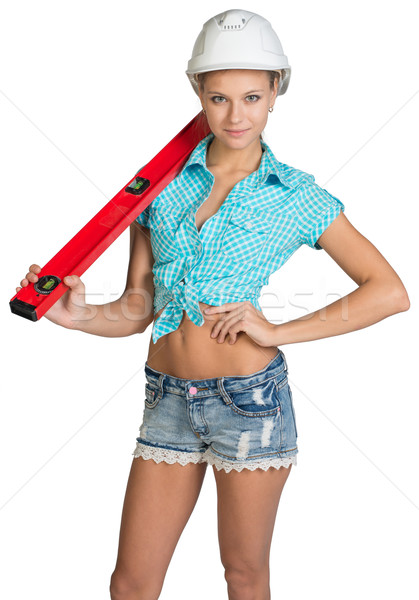 Beautiful girl in white helmet, shorts and shirt holding builder's level on the shoulder Stock photo © cherezoff