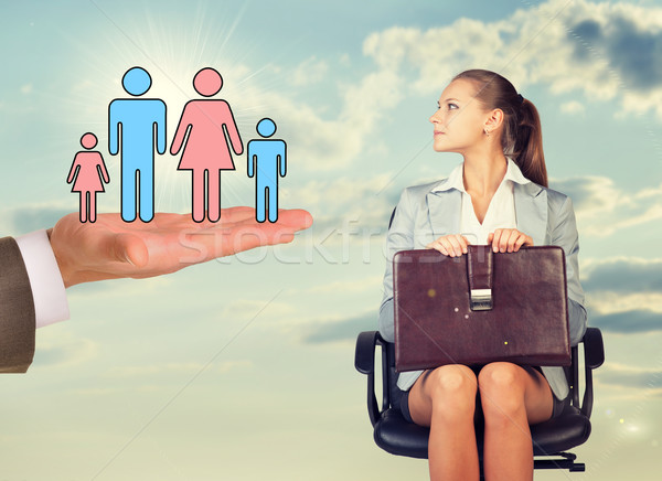 Stock photo: Young woman sitting in chair and looking at mans hand