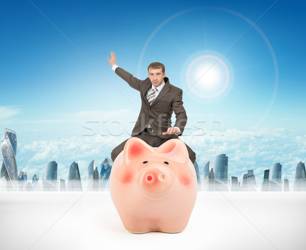 Man sitting on piggy bank Stock photo © cherezoff