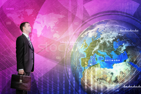 Businessman in front of holographic screen Stock photo © cherezoff