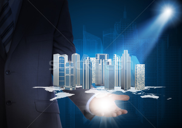 Man in suit holding skyscrapers in the hand Stock photo © cherezoff