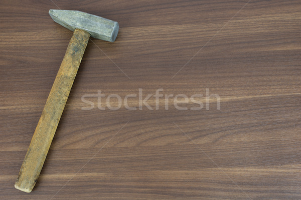 Old hammer on a wooden surface Stock photo © cherezoff