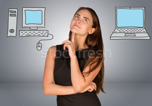 Woman making choice between desktop computer and laptop Stock photo © cherezoff