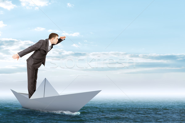 Businessman in paper boat Stock photo © cherezoff