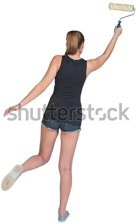 Woman using paint roller Stock photo © cherezoff