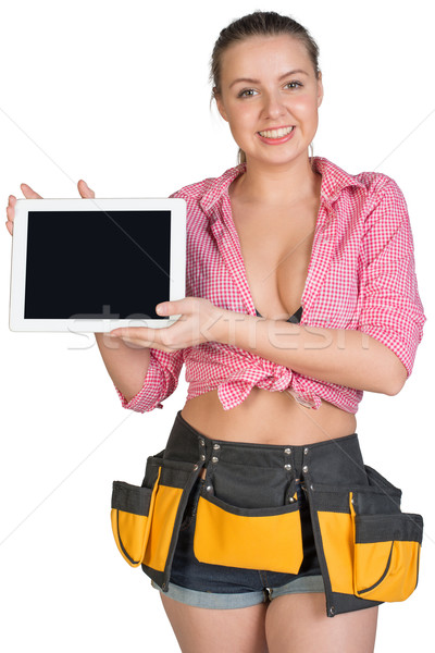 Woman in tool belt showing tablet PC with blank screen Stock photo © cherezoff
