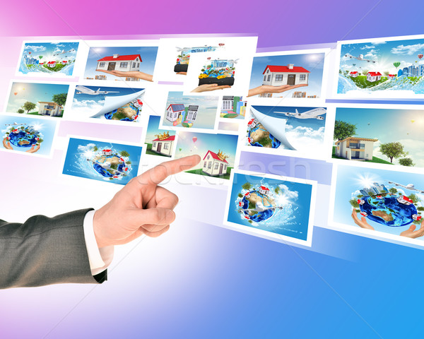 Businessmans finger touching holographic pictures Stock photo © cherezoff