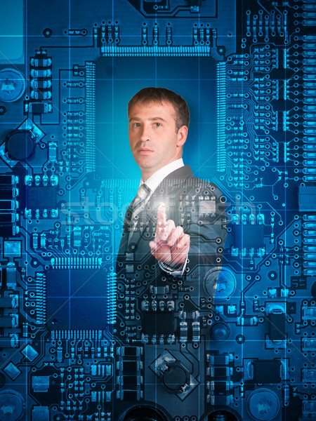 Businessman pressing on holographic screen Stock photo © cherezoff