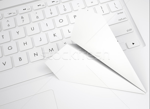White paper plane on the keyboard Stock photo © cherezoff