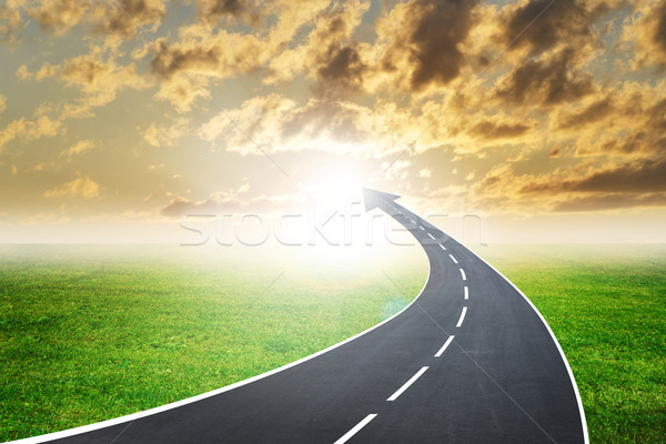 Stock photo: Highway road going up as an arrow in sunset