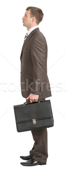 Businessman standing with suitcase Stock photo © cherezoff