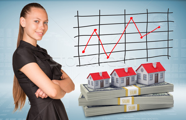 Businesswoman and dollar packs with row houses Stock photo © cherezoff