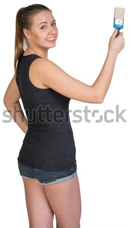 Woman holding paint-brush Stock photo © cherezoff