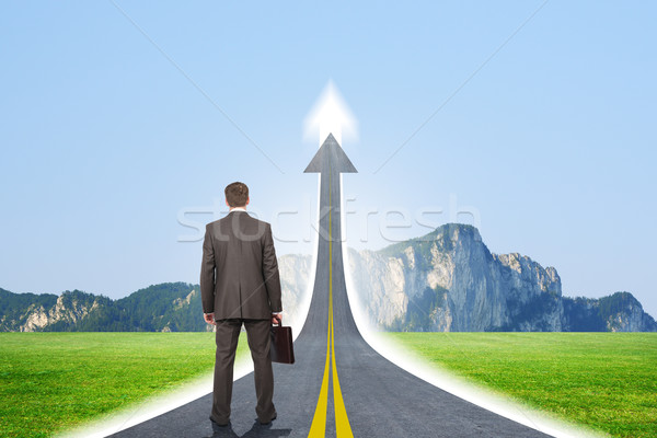 Person standing on roadway going up as arrow Stock photo © cherezoff