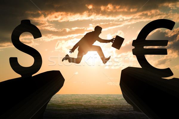 Businessman with suitcase hopping over abyss  Stock photo © cherezoff