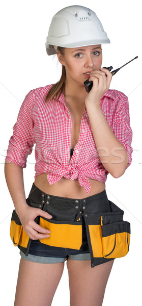 Stock photo: Woman in hard hat and tool belt talking on radio