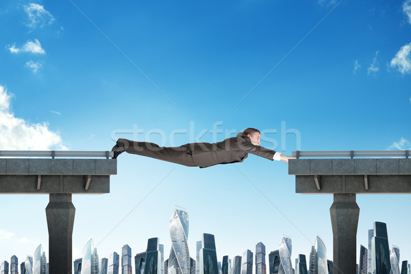 Businessman linking broken bridge Stock photo © cherezoff