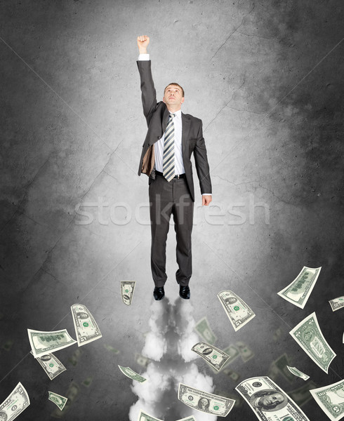 Businessman flying up Stock photo © cherezoff