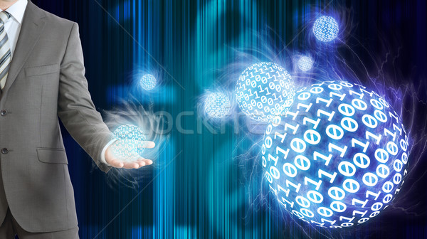 Businessman in suit hold spheres of glowing digits Stock photo © cherezoff