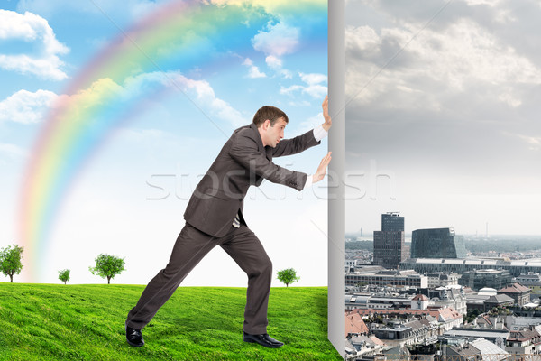 Businessman changing city on nature landscape Stock photo © cherezoff