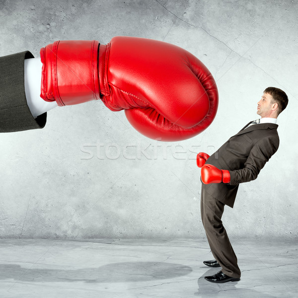 Businessman against red boxing glove Stock photo © cherezoff