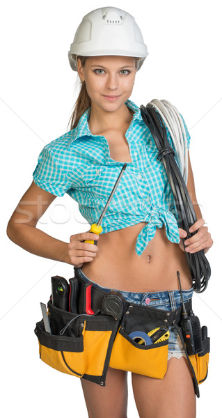 Pretty electrician in helmet, shorts, shirt, tool belt with tools holding screwdriver and an electri Stock photo © cherezoff