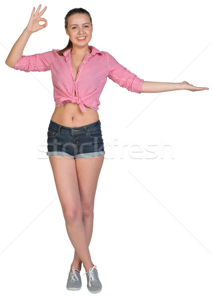 Woman showing something on her palm, making okay gesture Stock photo © cherezoff