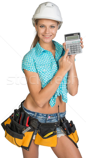 Woman in hard hat and tool belt showing calculator Stock photo © cherezoff