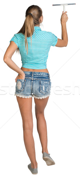 Woman using squeegee. Full length. Rear view Stock photo © cherezoff