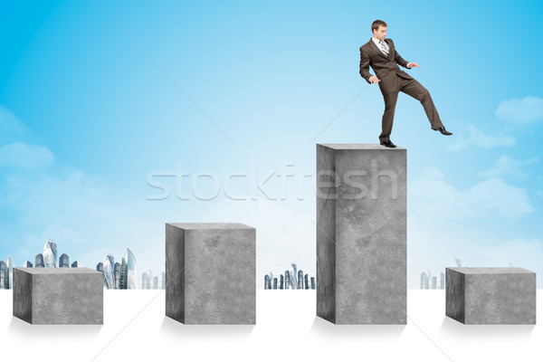 Businessman stepping up some cubes Stock photo © cherezoff