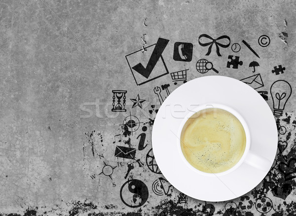 Coffee cup on concrete floor with various social icons Stock photo © cherezoff