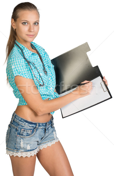 Woman with stethoscope writing on blank clipboard Stock photo © cherezoff