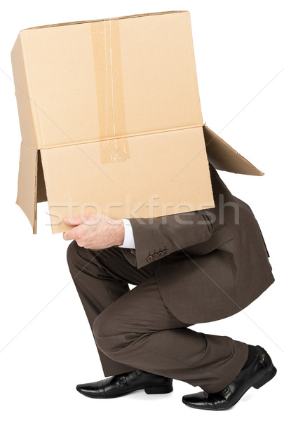 Businessman running with brown box on his head Stock photo © cherezoff