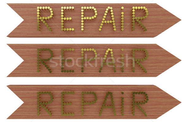 On a wooden board with nails gold embossed word 'REPAIR' Stock photo © cherezoff
