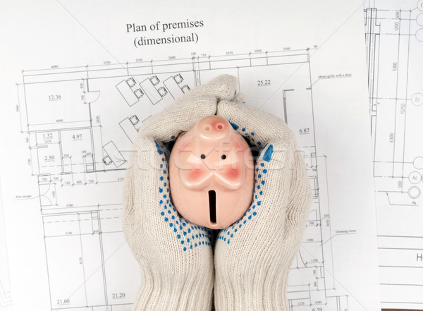 Mans hands in gloves holding piggy bank, top view Stock photo © cherezoff