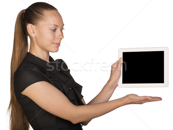 Beautiful girl in dress holding tablet and pointing at it Stock photo © cherezoff
