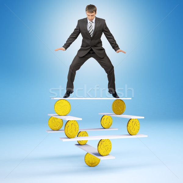 Businessman standing on balance with coins Stock photo © cherezoff