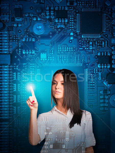 Businesswoman pressing on holographic screen Stock photo © cherezoff