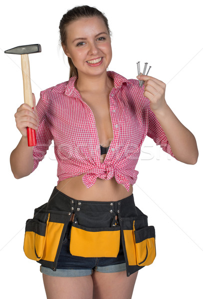 Woman in tool belt holding hammer and nails Stock photo © cherezoff