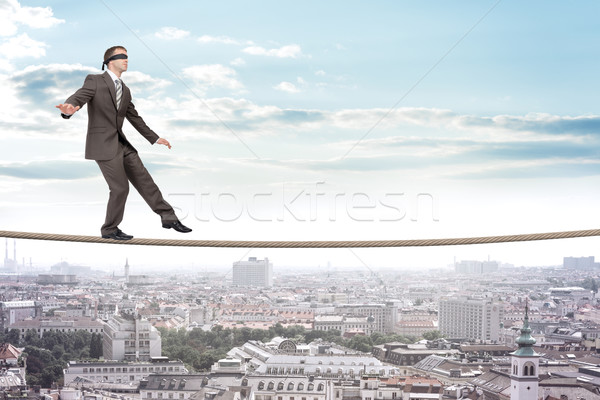 Businessman walking on rope Stock photo © cherezoff