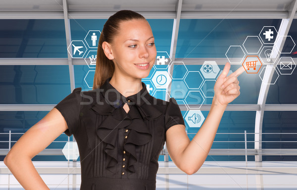 Buinesswoman pressing on holographic screen Stock photo © cherezoff