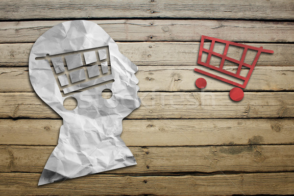 Paper humans head with shopping cart symbol Stock photo © cherezoff