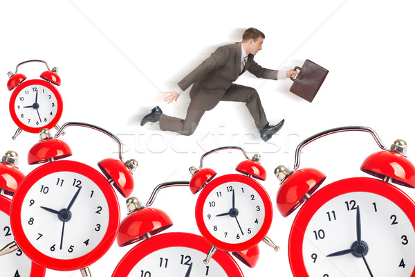 Empresario ejecutando alarma relojes aislado blanco Foto stock © cherezoff