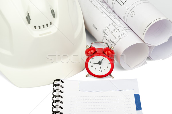 Blueprint rols and helmet with alarm clock  Stock photo © cherezoff