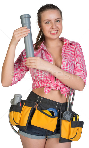 Woman in tool belt holding fitting pipe Stock photo © cherezoff